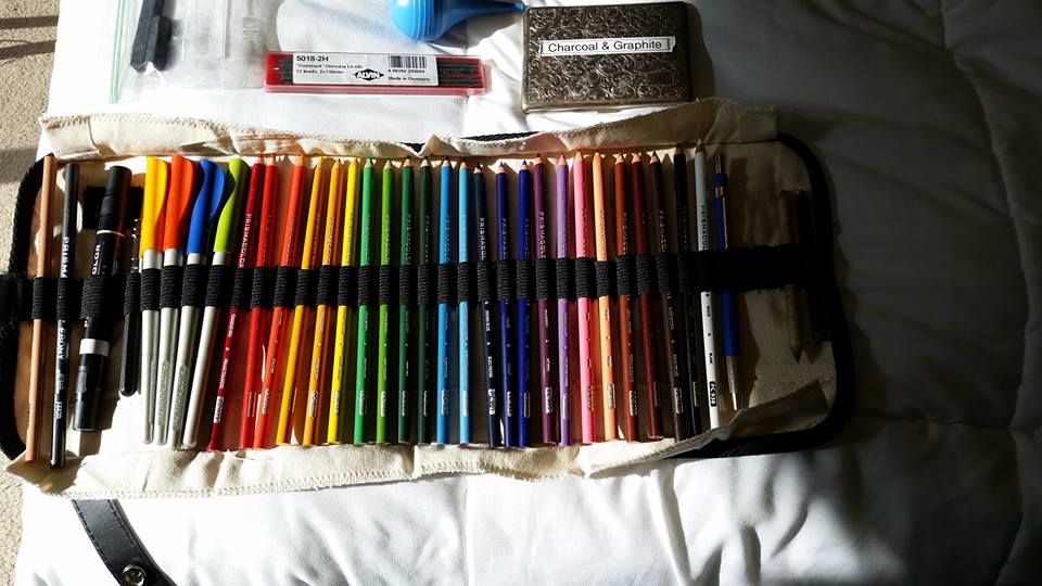 24 Colored pencils, drafting pencil, graphite pencil, smudger, 2 parallel pens, 2 blending pencils, 1 blending pen, and a pencil holder.